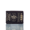 A 4 oz (113g) bar of The Immaculate Beard Natural Wash Bar For Men Deep Clean, wrapped in dark paper packaging. This natural beard wash combines refreshing spearmint, eucalyptus, and lavender to gently cleanse and revitalize your beard, leaving it feeling soft.