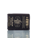 A black bar of The Immaculate Beard Natural Beard Wash Bar, a beard shampoo from The Immaculate Beard, features spearmint, eucalyptus, and lavender for natural beard care in a convenient bar format. The packaging displays product information in white text with a barcode on the right side.
