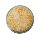 A glass jar of SALTOPIA Infused Sea Salts "BEN THERE, D'ONION THAT" Onion Salt—an all-purpose seasoning—seen from above on a white background.