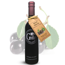 A bottle of Georgetown Olive Oil Co. BLACK CHERRY Balsamic Vinegar | Barrel Aged, Modena Italy, with a tag, displayed in front of a backdrop adorned with black cherries and green leaves. This premium balsamic vinegar from Georgetown Olive Oil Co. is barrel aged in Modena, Italy, and captures the bold, rich flavor of ripe black cherries in every drop.