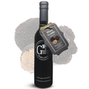 A bottle of Georgetown Olive Oil Co. BLACK TRUFFLE INFUSED Balsamic Vinegar, barrel-aged in Modena, Italy, with a tag attached, stands proudly before an enlarged image of black truffles. The label reads “Georgetown Olive Oil Co.”.