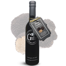 A dark bottle of Georgetown Olive Oil Co. Black Truffle Oil, crafted with extra virgin olive oil and high polyphenols, stands with a gray tag in front of a subdued black truffle background. The bottle features a black cap and displays the Georgetown Olive Oil Co. logo in white.