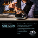 A bartender coats a glass rim in The Spice Lab Black Obsidian Salt Cocktail Rimmer from The Spice Lab on a plate. Text promotes this all-natural cocktail rimmer and instructs: pour salt, wet glass rim, rotate rim in salt, enjoy. An image of The Spice Lab Black Obsidian Salt Cocktail Rimmer appears in the bottom corner.