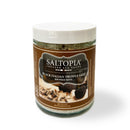 A jar of SALTOPIA Infused Sea Salts "KROSSED KEYS" Black Italian Truffle Salt, featuring Italian truffles and salt on a brown label, with a white lid, is set against a white background.