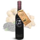 A dark bottle labeled Georgetown Olive Oil Co. Blackberry Ginger Balsamic Vinegar from Georgetown Olive Oil Co. stands in front of images of ginger root and blackberries, featuring a product tag hanging from its neck. The bottle contains aged balsamic vinegar from Modena, Italy.