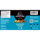 Texan Heartland Blackened Seafood Seasoning features a blue and black label displaying spices, nutrition facts, ingredients list, barcode, social media icons, and suggested uses for seafood, poultry, and vegetables. Infused with bold Gulf Coast flavor and expertly crafted by Texan Heartland for high-heat cooking, this seasoning delivers authentic Southern taste to all your favorite dishes.