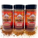 The Blazing Star BBQ Barbecue Bundle by Blazing Star BBQ includes three spice bottles—All In One, Beef, and Pork—each adorned with an illustrated mascot and spices scattered on a white background, making this bundle the perfect choice for anyone seeking an all-in-one seasoning or a flavorful beef rub.