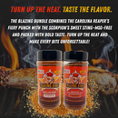 Two bottles of Blazing Star BBQ’s Blazing Bundle are displayed in front of barbecue ribs and flames, with striking text highlighting the spicy, flavorful Carolina Reaper BBQ Rub and Trinidad Moruga Scorpion Seasoning featured in this fiery BBQ package.