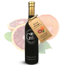 A dark glass bottle of Georgetown Olive Oil Co. Blood Orange Fused High Polyphenols Extra Virgin Olive Oil with a brown tag, displayed in front of whole and sliced blood oranges. This exceptional high polyphenol extra virgin olive oil from Georgetown Olive Oil Co. is expertly fused to capture the vibrant essence of blood oranges in every drop.