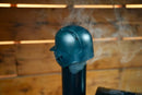 A black Baseball Batting Helmet BBQ Chimney Cap - Black | Pimp My Grill® resting on a pellet grill chimney with smoke rising from it.
