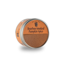 A tin of Bourbon Barrel Foods Bourbon Smoked Pumpkin Spice with an orange lid is partially open, showing the smoky spice blend. The simple design features bold black text and a barrel graphic—ideal for adding warmth to fall recipes.