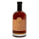 Under The Bark Syrup Co Bourbon Maple Syrup comes in a 23.3 fl oz (750 ml) bottle with amber syrup inside and a beige maple leaf label, featuring 100% pure maple syrup and Bourbon labeling from Under The Bark Syrup Co.