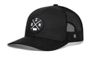 The Haka Hat Bozeman Trucker Hat | Black BZN X Snapback features a mesh back and a round embroidered front patch with white “Z,” “B,” “N” letters and a central shape, shown on a white background.
