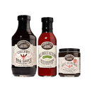 The Brownwood Farms Summer Cookout Trio includes three bold sauces—Cherry BBQ Sauce, Dill Pickle Ketchup with Bourbon, and Maple Bacon Onion Spread—each in a jar featuring a vintage-style cream-colored label, perfect for adding artisanal charm to your table.