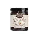 A jar of Brownwood Farms Raspberry Champagne Jam featuring a black lid and a cream-colored label with illustrations of raspberries and product information.
