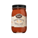 A 16-ounce jar of Brownwood Farms Three Cheese Vodka Pasta Sauce features a beige label and black lid, highlighted with cheese imagery and text emphasizing its cheese and vodka ingredients. This creamy tomato sauce is enriched with robust dairy flavors, inspired by Snowville Creamery, making it an excellent choice for pasta enthusiasts looking for a decadent taste experience.