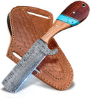 The Texan Knives Custom Handmade Bull Cutter features a Damascus steel blade and a wood-turquoise handle, resting on a stitched brown leather sheath with belt loops—an essential for ranch and leatherwork.