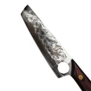 The Spaceman Knives Meteor Series Chef Knife features an 8.5-inch hammered stainless steel blade and a wooden handle, shown on marble near a black cloth and a box with the circular Spaceman Knives logo.