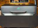 A stainless steel Pimp My Grill® Bodyguard for Green Mountain Grills Ledge 1.0 / Daniel Boone installed on the front of a pellet grill to protect against grease and paint damage.