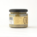 A glass jar with a black lid contains Famiglia Crispino Porcini Mushroom Bruschetta Spread — Wild Italian Funghi by Taycte. The label shows nutritional info and partial branding. The jar sits against a plain white background.