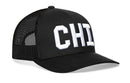 The Haka Hat Chicago White Block Trucker Hat is a black mesh snapback with a curved brim and bold white “CHI” on the front, featuring the signature 5.0 design by Haka Hat.