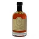 Under The Bark Syrup Co Cardamom Maple Syrup, 100% pure maple syrup with cardamom pods and a beige label featuring a maple leaf, offers a distinctive cardamom-infused flavor for a unique twist.