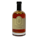 Under The Bark Syrup Co Cardamom Maple Syrup is a 100% pure amber maple syrup infused with cardamom and visible cardamom pods. It comes in a glass bottle with a beige label, black text, and a leaf logo.