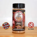 A bottle of brisket & steak seasoning sits on a table, an ideal choice for anyone seeking quality BBQ brisket rubs. Featuring the MSG & Gluten Free and GO TEXAN logos, and a cartoon cowboy on a steer, this seasoning makes the perfect addition to the DDR BBQ Supply Top 10 Store-Bought BBQ Brisket Rubs Variety Pack—an essential set for any grilling enthusiast.