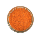 A glass jar of SALTOPIA Infused Sea Salts, labeled "Saltopia Cheese Salt: CHEDDAR CHEESE," filled with orange-red cheddar seasoning powder and viewed from above against a white background.