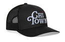 The Haka Hat Chi Town White Script Trucker Hat is a black Illinois snapback featuring "Chi Town" in white embroidery, a small red star above the "i," black mesh panels, and an adjustable closure for comfort.