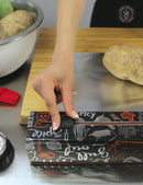 A hand slides the ChicWrap BBQ Grill Aluminum Foil Refillable Dispenser 12" x 30' on a kitchen counter near a cutting board with a potato, large metal bowl, red brush, and thermometer.