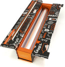 A roll of ChicWrap BBQ Grill Aluminum Foil (12" x 30') is partially pulled from the decorative refillable ChicWrap dispenser, featuring themed graphics and a built-in cutting edge on the lid.
