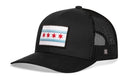 The Haka Hat Chicago Flag Trucker Hat | Black City Snapback by Haka Hat features a black mesh design with an embroidered city flag patch, displaying blue stripes and four red stars representing the iconic Chicago flag.