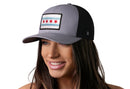 A woman wears the Haka Hat Chicago Flag Trucker Hat, a gray-black city snapback that blends style and city pride.