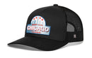 The Haka Hat Chicago Windy City Trucker Hat is a black mesh snapback with a curved brim, featuring cityscape embroidery on a patch reading "Windy City Chicago Illinois" with skyline, red stars, and a light blue background.