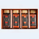 Introducing the Spice Wheel Fiery Four Gift Set – A Global Heat Collection by Spice Wheel. This beautifully curated spice gift set features four jars of premium chili powders: Aleppo Pepper, Kashmiri Powder, Cayenne, and Guajillo Chili Powder. Each jar is elegantly topped with a wooden lid and neatly arranged in a row against a plain background—a vibrant array of global chili peppers perfect for adding fiery flavor to any kitchen.