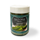 A 6oz jar of SALTOPIA Infused Sea Salts’ Chive Salt: DIVE INTO CHIVES, featuring a white lid and an image of chopped chives, makes the perfect herb finishing salt for your favorite dishes.
