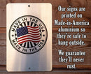 Metal sign with 'Made in the USA' stamp on a wooden background
