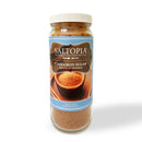 A 16oz clear jar of SALTOPIA Infused Sea Salts Cinnamon Sugar: CRACKLIN' HEIGHTS, with a blue label showing a bowl of cinnamon sugar—ideal for baking or adding a gourmet touch to your favorite treats.