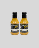 Two identical bottles of Gourmet Carolina Gold Classic Carolina Gold BBQ Sauce with black labels reading Carolina gold Classic Sauce.