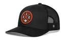 The Haka Hat Cleveland Trucker Hat in black features a breathable mesh back, signature trucker style, and a front round orange patch with crossed lines, CLE lettering, and a football icon.