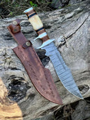 The Texan Knives Damascus Steel Sub-Hilt Fighter Bowie Knife 14” features a wavy-patterned blade, white and brown handle, and comes with an embossed leather sheath—an impressive premium Christmas gift.