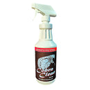 A white 32 oz spray bottle of Cobra Clean Biodegradable Grease Cleaner, an industrial, heavy-duty degreaser from Cobra Clean, sits on a brown surface with a wooden background. The label features red text and a cobra image.