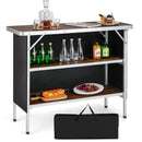 The DirectDeals Folding Camping Table with 2-Tier Open Shelves for Outdoor BBQ holds drinks, snacks, and more. It has a black cover, wood-style top and shelves, plus a folded carrying case in front.