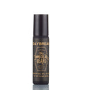 A black cylindrical bottle labeled “The Immaculate Beard Cologne Oil” by The Immaculate Beard, adorned with gold lettering and standing upright on a white background, delivers the sophistication of a scented travel perfume in the form of a nourishing cologne oil.