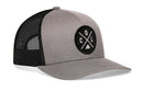 The Haka Hat Colorado Trucker Hat features a gray and black design, mesh back, and a round front patch with COL letters and a mountain graphic.