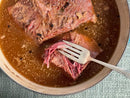 With the World Spice Corned Beef Cure & Cook Kit from World Spice, tender homemade corned beef shreds effortlessly in a pot of savory, aromatic broth—fat, peppercorns, and signature seasonings floating on top for a classic St. Patrick’s Day meal made to perfection.