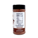 The back of the Hickman's BBQ Cowgirl Gluten Free Natural Keto Friendly BBQ Rub 11.4 oz container is shown, highlighting its nutrition facts, ingredient list, and manufacturer information on the label. This gluten free BBQ rub from Hickman's BBQ features a keto friendly seasoning blend, and the reddish-brown mixture inside promises bold flavor for your favorite dishes.