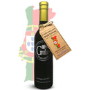 A bottle of Georgetown Olive Oil Co Cobrançosa (PORTUGAL) Extra Virgin Olive Oil from Georgetown Olive Oil Co. with a tan tag stands in front of a faded Portugal map and flag. The tag highlights Cobrançosa PORTUGAL, Fresh Harvest, and High Polyphenols, emphasizing this medium intensity EVOO as an exceptional Portuguese olive oil.
