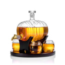 The Craftgen Barrel Whiskey Decanter Set by Craftgen features a barrel-shaped glass decanter with brass spigot on a black stand, four round glasses, and a tray—an ideal centerpiece for your home bar.